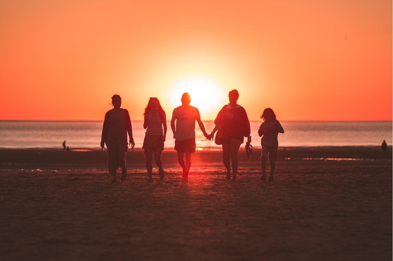 Life Insurance: A family on the beach watching the sunset.