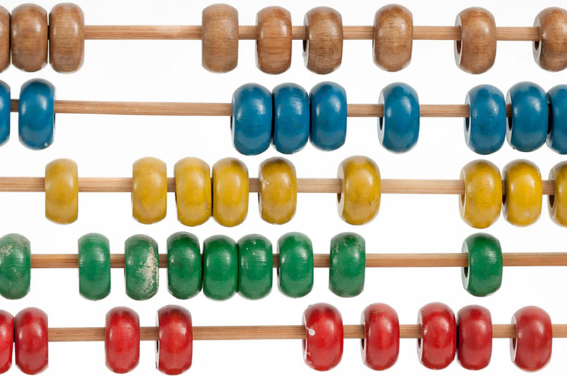 Financial Calculators & Resources: A close up of an abacus with colourful painted wooden beads.